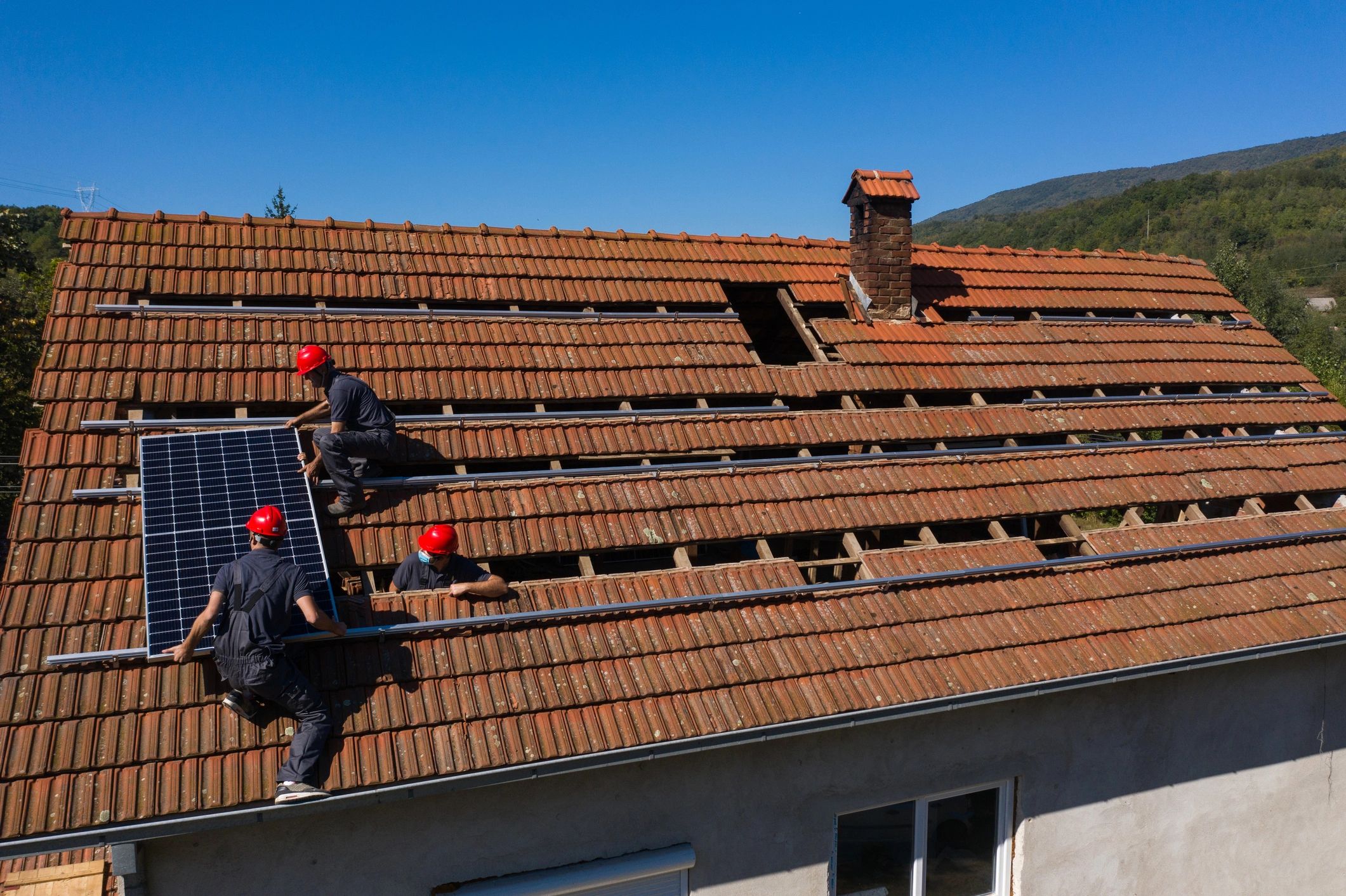 Aerial view of exterior crew working on a residential roof