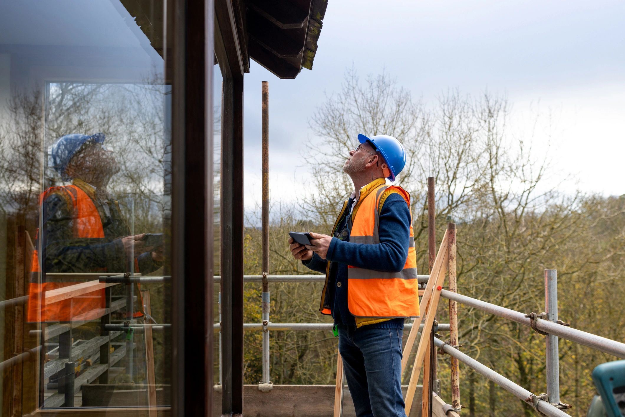 Roof inspector documenting findings during an exterior inspection