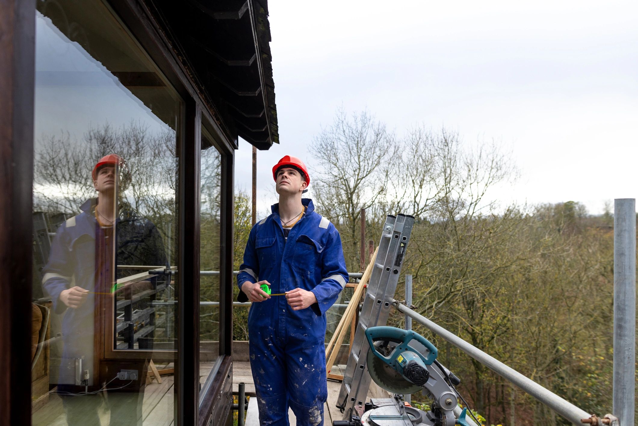Contractor assessing measurements during property inspection